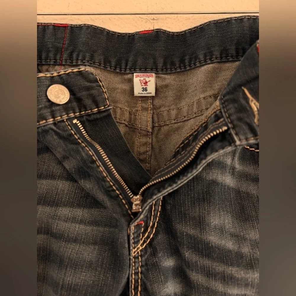 True Religion jeans feature a dark wash and bold signature stitching. Skinny